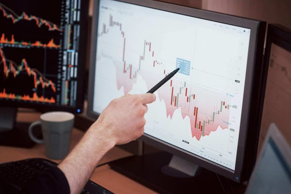 A chart on a computer monitor showing stock market data with red and green candlesticks.
